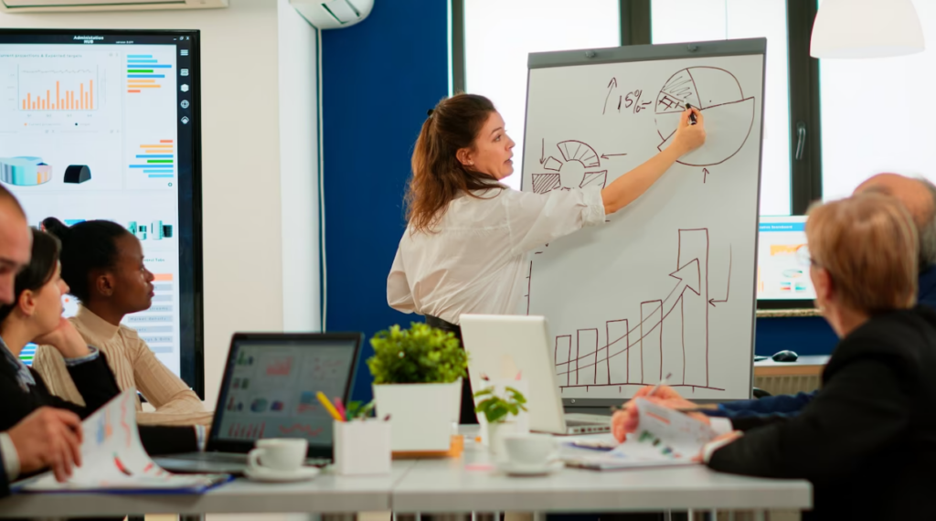 Focused team leader presenting marketing plan to interested multiracial coworkers